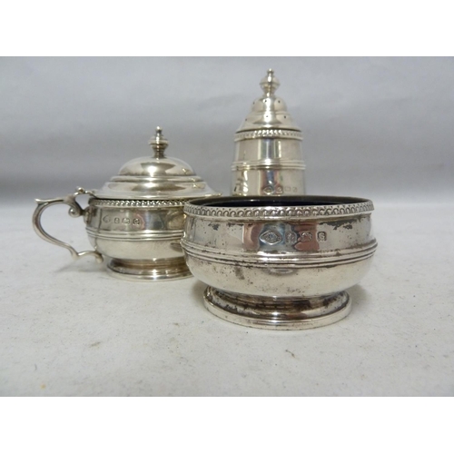 24 - A three piece silver cruet, decorated with beaded and reeded bands beneath vase finials, comprises p... 