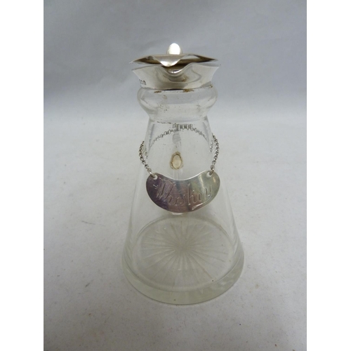 5 - A Whisky noggin, the cut glass flask shaped jug mounted in silver with flip up lid, thumbpiece and l... 