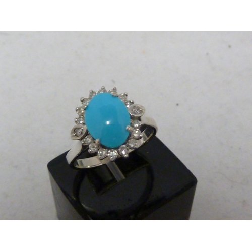 82 - A turquoise and diamond ring, the oval turquoise encircled by 18 round brilliant cut diamonds, set i... 