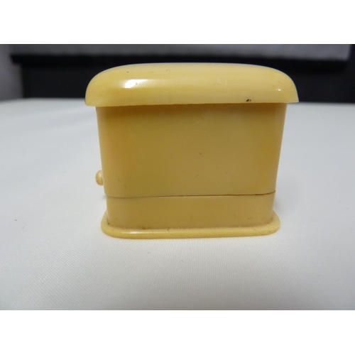 34 - Cartier - a bakelite ivorine ring box, push button fastening, cream silk and velvet lined and stampe... 