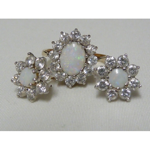 40 - A light opal ring and earring set, the opals encircled by CZ stones, the ring of 9ct yellow gold, ri... 