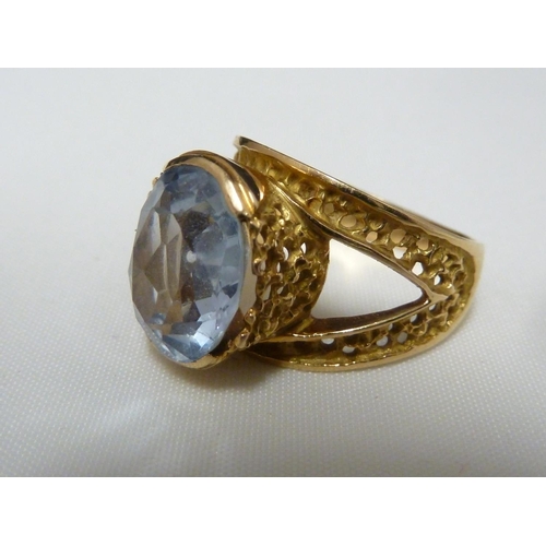 53 - An aquamarine set ring, set in pierced yellow metal, stamped with Arabic marks; a marquise ring and ... 