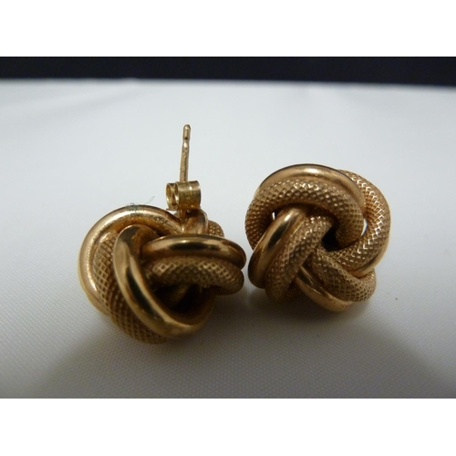 62 - A pair of 9ct yellow gold knot form earrings; and six pairs of yellow metal earrings, 10grms total w... 