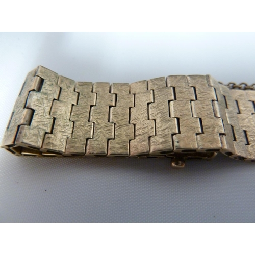 81 - A 9ct yellow gold textured articulated bracelet, 25.5grms; and a 1970's Rotary gold plated bark effe... 