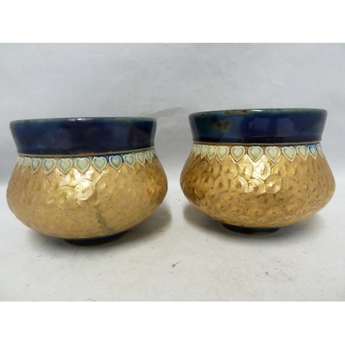 102 - A pair of Royal Doulton stoneware vases, of gourd form, banded in gold with incised swirls between b... 