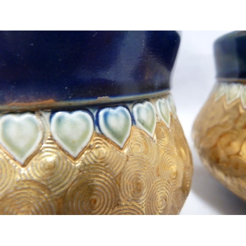 102 - A pair of Royal Doulton stoneware vases, of gourd form, banded in gold with incised swirls between b... 