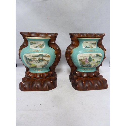 129 - A pair of Chinese porcelain bookends, formed as flat backed porcelain wall vases on carved hardwood ... 