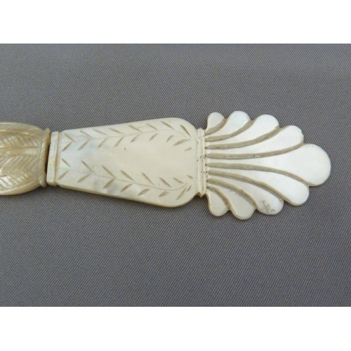 126 - A Regency mother of pearl letter knife, the handle formed as a neo-classical vase with acanthus leaf... 