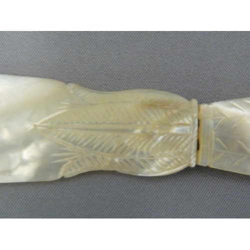 126 - A Regency mother of pearl letter knife, the handle formed as a neo-classical vase with acanthus leaf... 