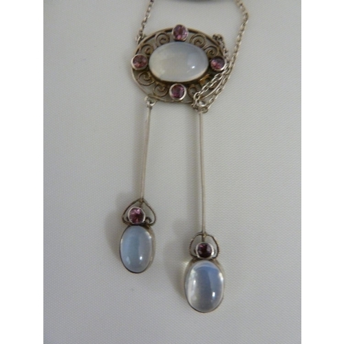 36 - A Belle Epoque pendant and brooch set, the white metal filigree work supporting oval moonstones and ... 