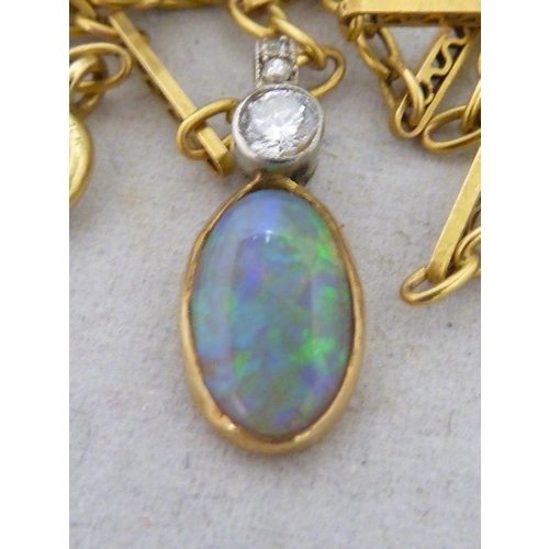 44 - An opal and diamond pendant, the oval opal set in yellow metal, surmounted by a single round brillia... 