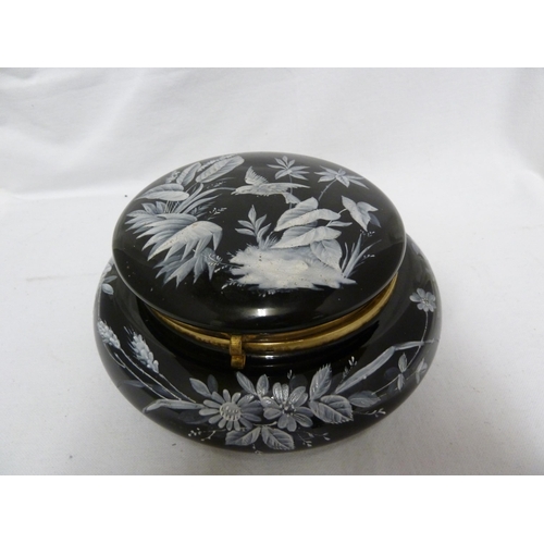 61 - Bohemian Glass - An enamelled amethyst glass box and cover, circular painted in white with a bird am... 