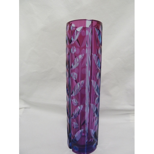 245 - Karel Wunsch - a cut glass cylinder vase, the fuschia overlay cut through to purple/blue with a styl... 