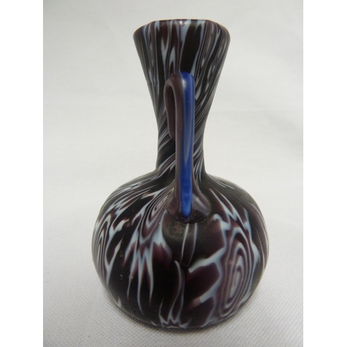 178 - Fratelli Toso - a fused millifiore cane glass vase of small size, bottle form with two high loop han... 