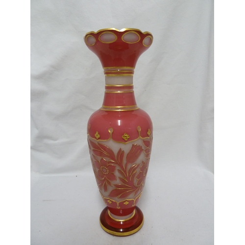 64 - Bohemian Glass - a pink over white cameo glass vase, cut through with flowers and with gilded highli... 