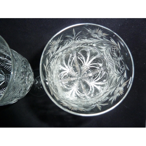 99 - Stevens and Williams - a pair of rock crystal wine glasses, the bowls decorated with four acanthus l... 