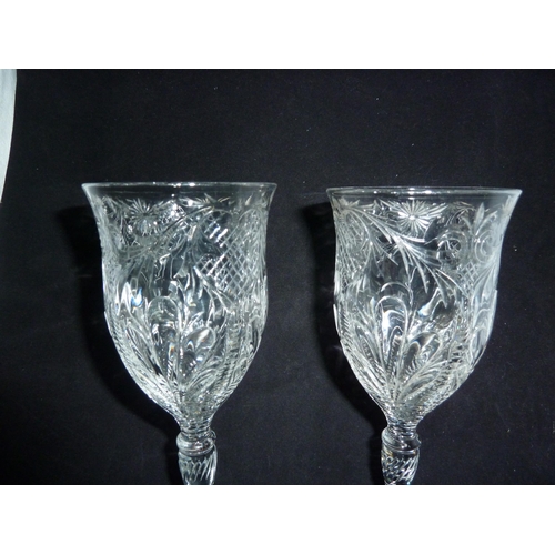 99 - Stevens and Williams - a pair of rock crystal wine glasses, the bowls decorated with four acanthus l... 