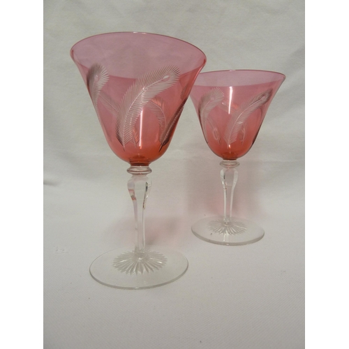 141 - James Powell and Sons, Whitefriars Limited - a pair of wine glasses with red cut through to colourle... 