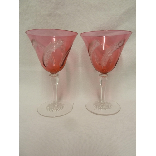 141 - James Powell and Sons, Whitefriars Limited - a pair of wine glasses with red cut through to colourle... 