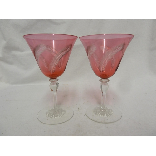 141 - James Powell and Sons, Whitefriars Limited - a pair of wine glasses with red cut through to colourle... 