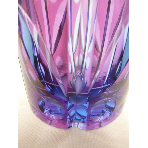 245 - Karel Wunsch - a cut glass cylinder vase, the fuschia overlay cut through to purple/blue with a styl... 