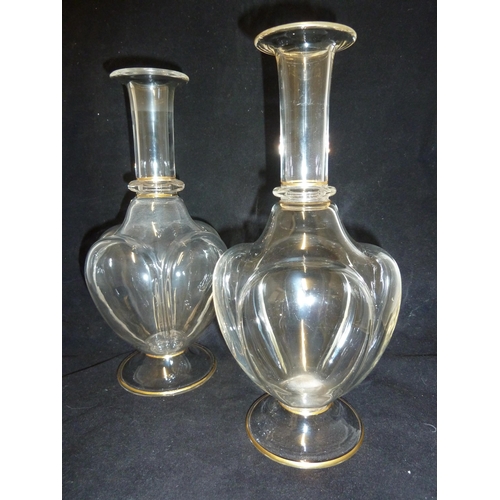 45 - Lobmeyr - a pair of water carafes, of lobed  bottle form with gilding, 27.5cm