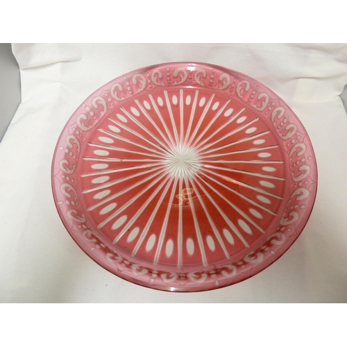 67 - Bohemian - a red flashed glass tray, circular, the base cut with a sunburst within a gallery edge cu... 