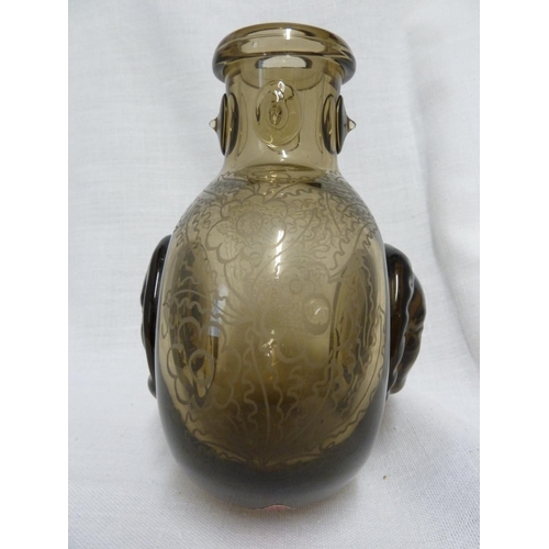 173 - Seguso - a smoke glass flattened bottle vase, decorated with a Jean Cocteau style design of applied ... 