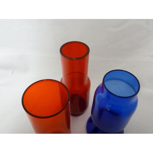 244 - Jan Gabrhel for Chribska Sklo, three glass cylinder vases, two of red colour and one of blue, Czecho... 