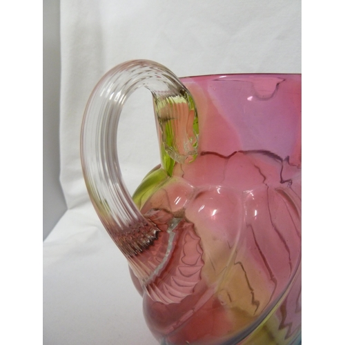 103 - Stevens and Williams - a Rainbow glass jug, of ovoid wrythen moulded body with applied colourless fl... 