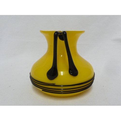 3 - Loetz - a Tango glass urn, of bright yellow over white applied with bifurcated angular glass handles... 