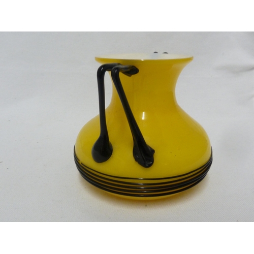 3 - Loetz - a Tango glass urn, of bright yellow over white applied with bifurcated angular glass handles... 