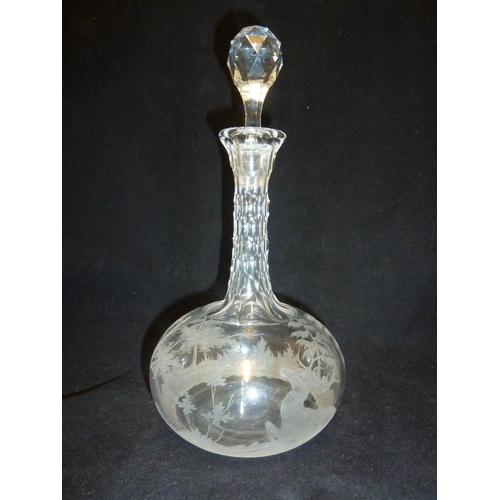 69 - Bohemian Glass - a decanter and stopper, the body engraved with a stag in a wooded landscape beneath... 