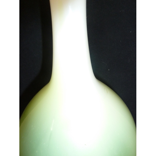 232 - Joseph Hodspodka - an ovoid glass bottle vase, in white graduating to bright green cased glass, part... 