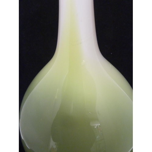 232 - Joseph Hodspodka - an ovoid glass bottle vase, in white graduating to bright green cased glass, part... 