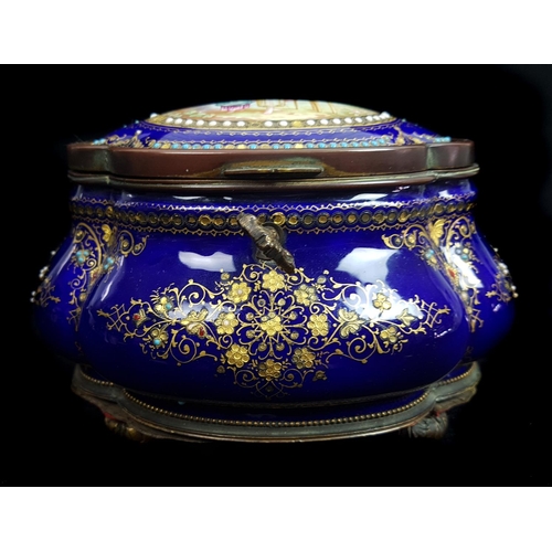 260 - A Limoges enamelled metal casket and cover of quatrefoil bombe form, the deep cobalt blue ground dec... 