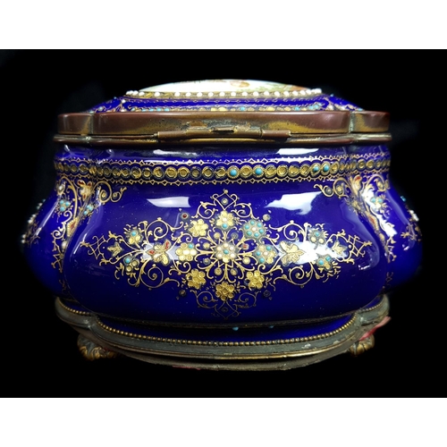 260 - A Limoges enamelled metal casket and cover of quatrefoil bombe form, the deep cobalt blue ground dec... 