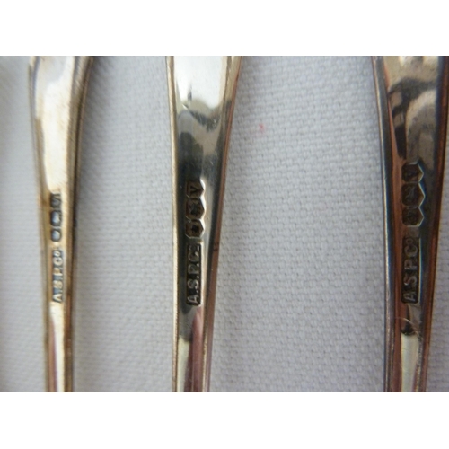 13 - A cased set of silver teaspoons, with flared terminal above a scrolled capitol motif, Sheffield 1963... 