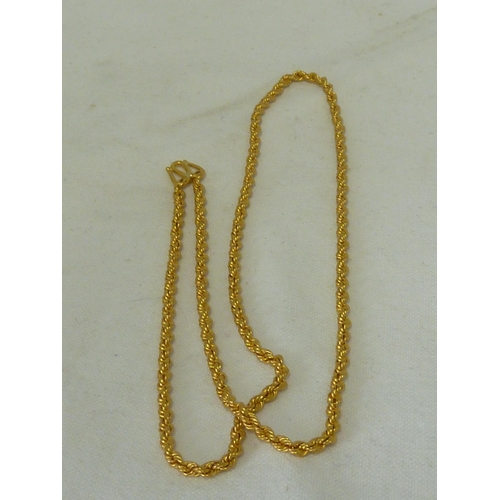 22 - A heavy yellow metal rope twist necklace, marked indistinctly, tests as 22ct, 60cm long, 45.3 grms a... 