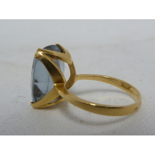 35 - An aquamarine set dress ring, of facetted and rounded rectangular form set in yellow metal, ring siz... 