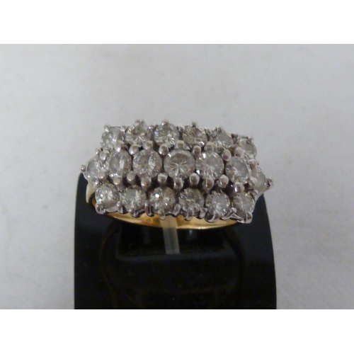 37 - A diamond cluster ring, the round brilliant cut stones arranged in three rows on a hallmarked 18ct y... 