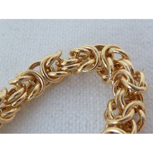 42 - A hallmarked 9ct yellow gold fancy link bracelet, 23.5cm long, 10.4 grms