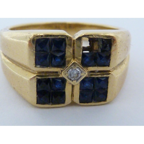 58 - A sapphire and diamond ring, the design of four squares of four sapphire stones about a central roun... 