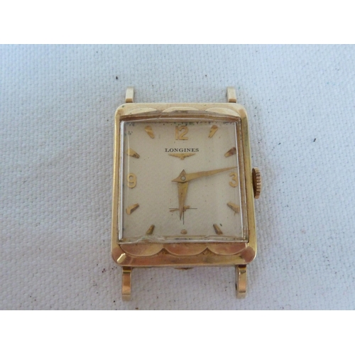 A Longines tank form wristwatch stamped 14K gold apex the