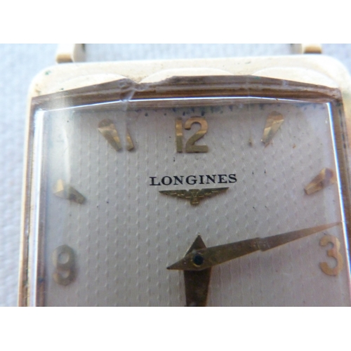 A Longines tank form wristwatch stamped 14K gold apex the