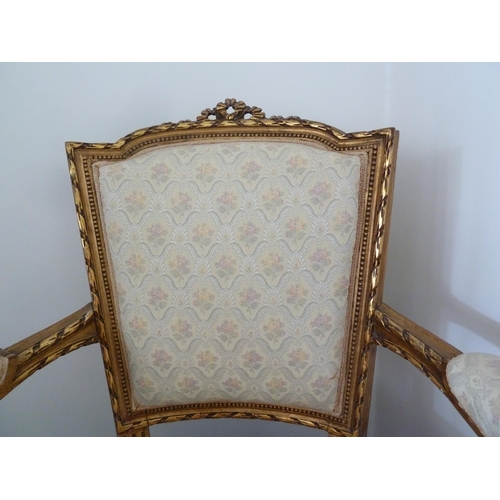 176 - A Louis XVI style salon set of six side chairs and two chairs with arms, gilded gesso frames surmoun... 