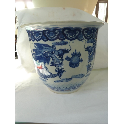 177 - A Chinese fish bowl jardiniere, decorated in blue with a coiled five claw dragon chasing a flaming p... 