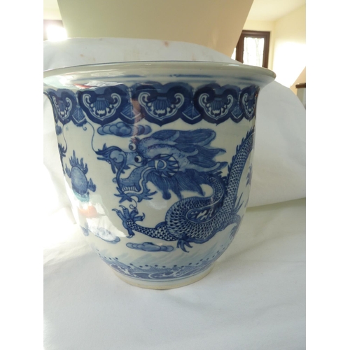 177 - A Chinese fish bowl jardiniere, decorated in blue with a coiled five claw dragon chasing a flaming p... 