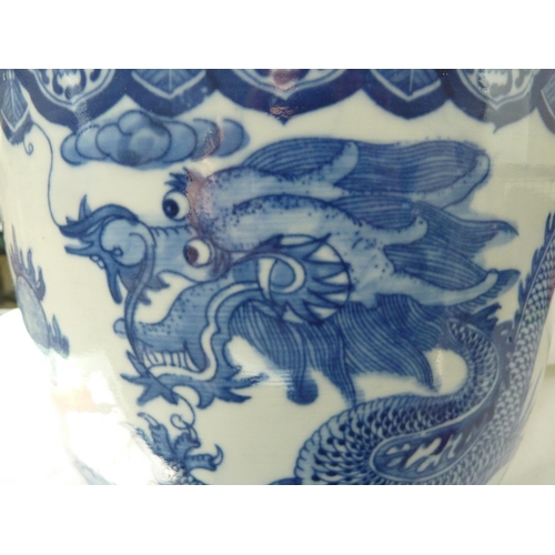 177 - A Chinese fish bowl jardiniere, decorated in blue with a coiled five claw dragon chasing a flaming p... 