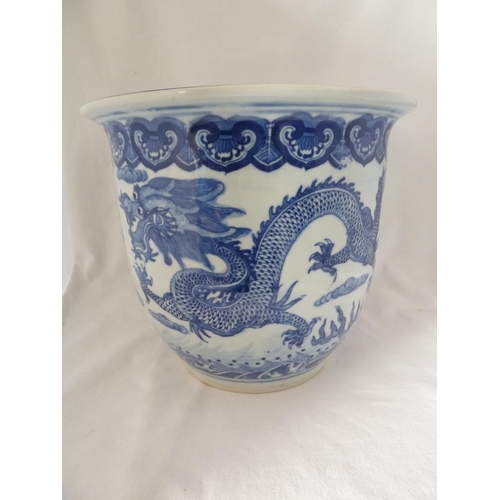 177 - A Chinese fish bowl jardiniere, decorated in blue with a coiled five claw dragon chasing a flaming p... 